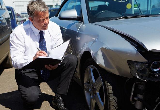 smiling person holding auto insurance card